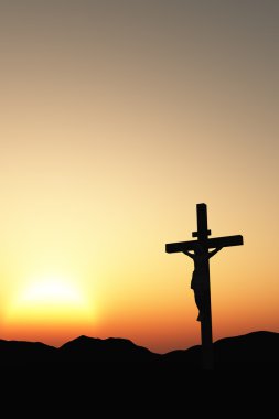 Crucifixion and sunset vertical clipart