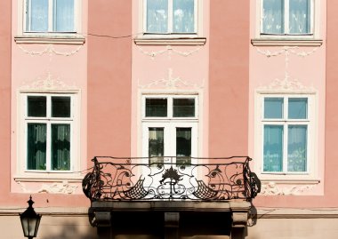 Facade of a building with a balcony. clipart