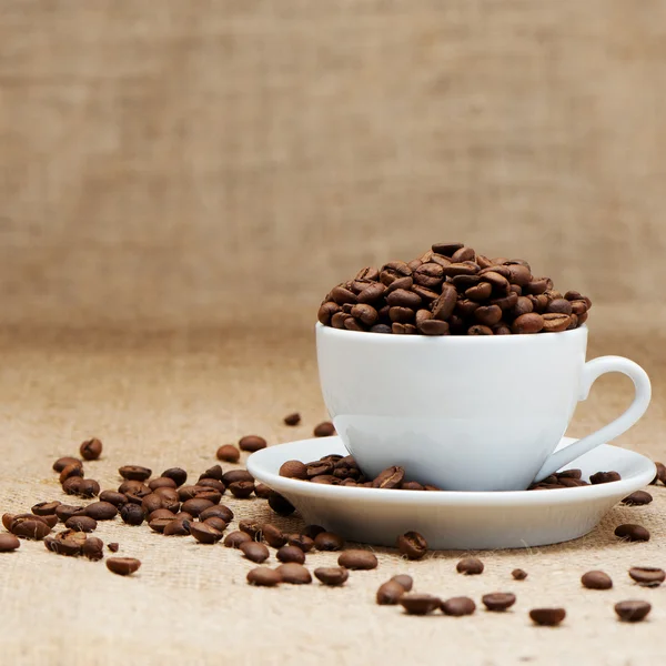 Vit kopp med kaffe korn — Stockfoto
