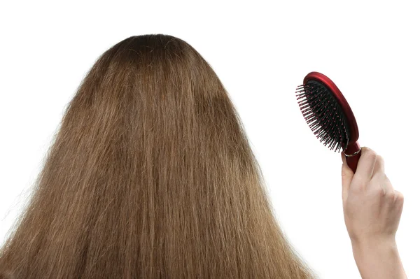 Flickan med långt hår och en hårborste — Stockfoto