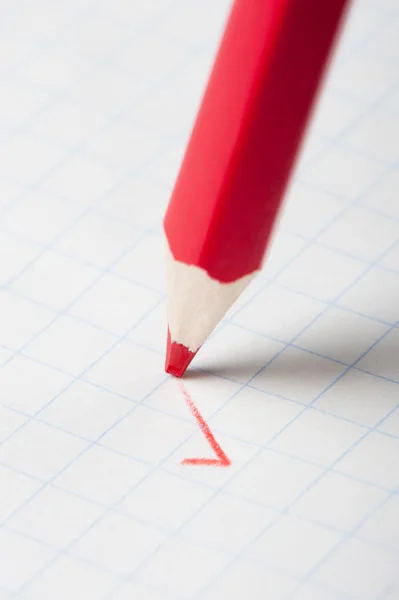 Red pencil writing a mark — Stock Photo, Image