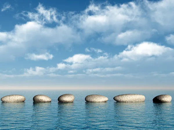 Una fila di pietre in acqua — Foto Stock