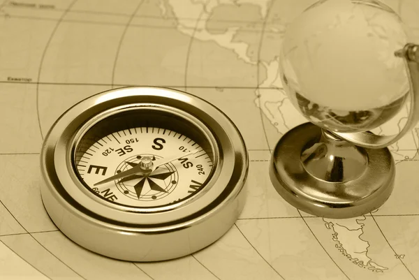 Ancient compass and glass globe — Stock Photo, Image