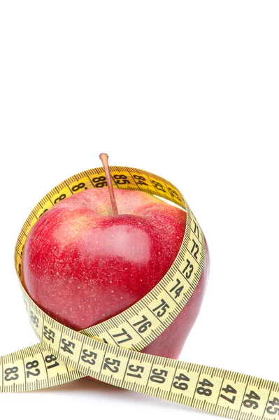 Closeup of a red apple with a measuring tape. Isolated on white — Stock Photo, Image