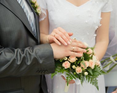 Hands of a newly-married couple clipart