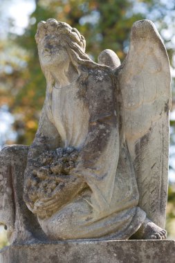 Monument to an angel on a cemetery clipart