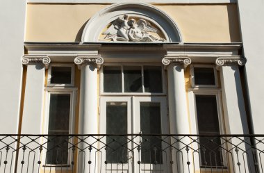 Facade of a building with a balcony. clipart