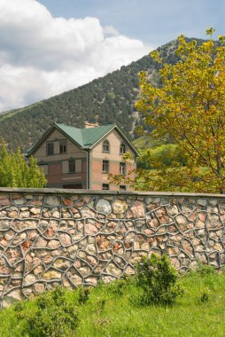 The house and stone fence clipart