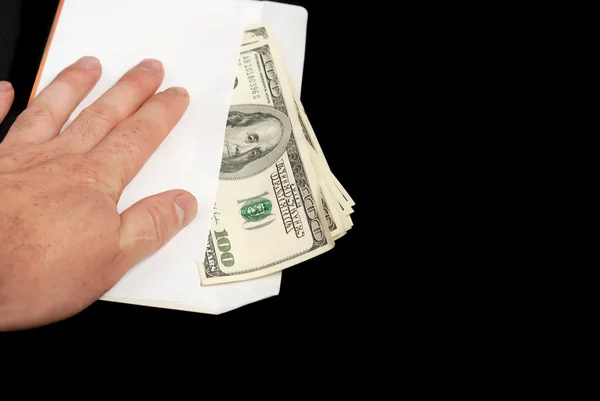 Bribe in an envelope and hand — Stock Photo, Image