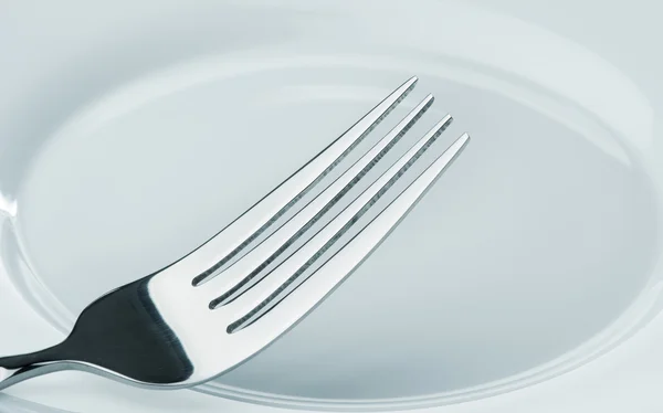 Tenedor en un plato —  Fotos de Stock