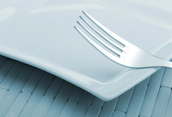 Fork laying on a plate — Stock Photo, Image