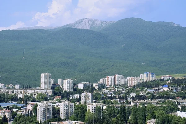 stock image Modern city located in an environment of mountains