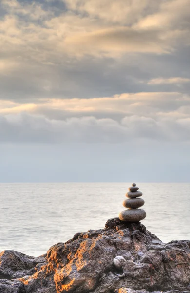 Pebble and stones on a background of the drama sky — Stock Photo, Image