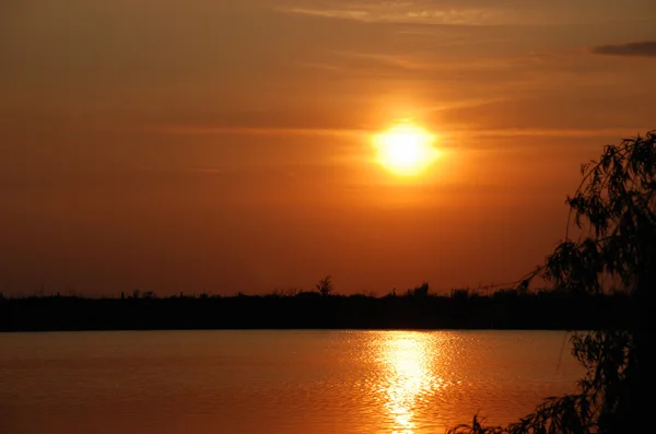 stock image Sunset above water