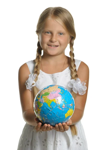 stock image The girl holds the globe collected from puzzle in hands. Selecti
