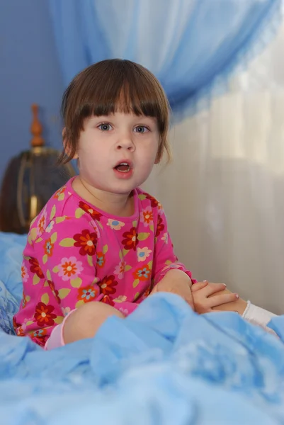 Маленькая девочка на кровати — стоковое фото