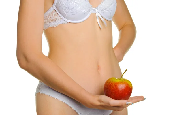 Femenino bien formado un cuerpo y una manzana roja — Foto de Stock