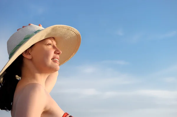 La fille dans un chapeau contre le ciel bleu — Photo