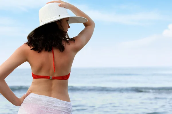 Жінка на узбережжі моря в капелюсі — стокове фото