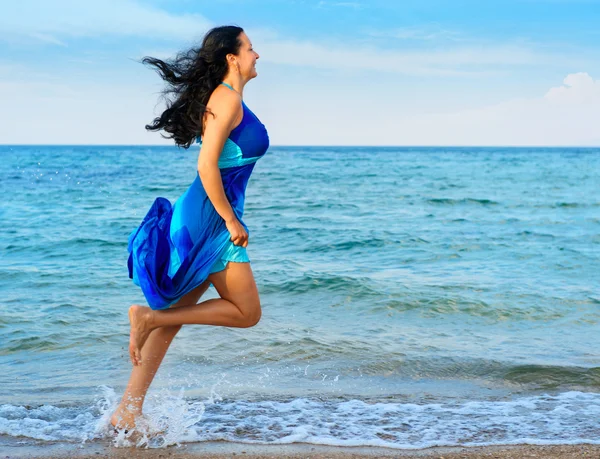 Женщина бежит по берегу моря — стоковое фото