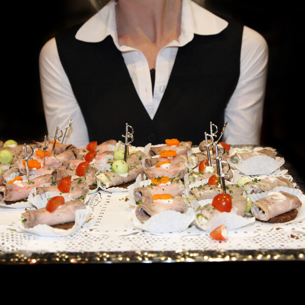 Waitress serving finger food.