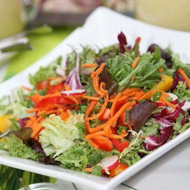 Mixed fresh salad with peppers, lettuce, tomatoes and carrot clipart