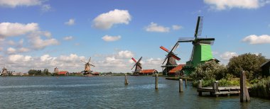 Panoramic view on river and winmills. clipart