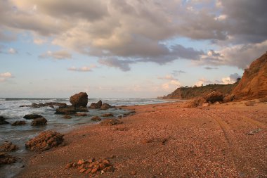 Red sand on the shores of Mediterranean Sea. clipart