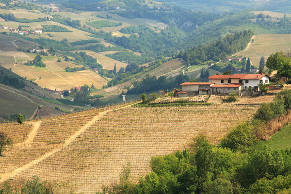 Aerial view on lone rural house on the hills in Italy.