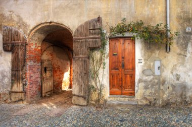 Wooden door and gate in brick house. clipart