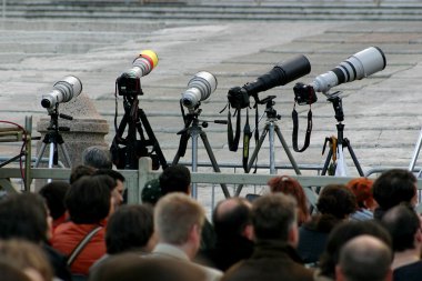 DSLR photo cameras with telephoto lenses on tripods. clipart