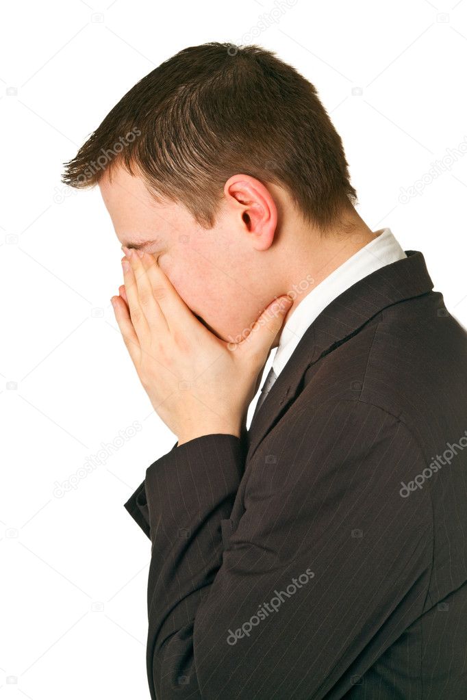 Businessman hiding his face in shame