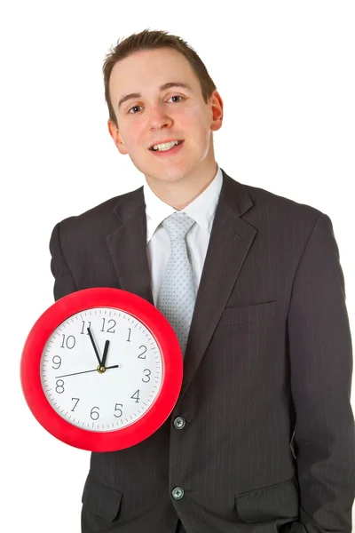 Jovem empresário segurando um relógio — Fotografia de Stock
