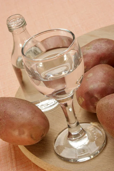 Potato vodka in a glass and a small bottle — Stock Photo, Image