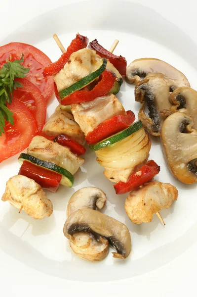 Chicken kebab on a white plate with organic pepper — Stock Photo, Image