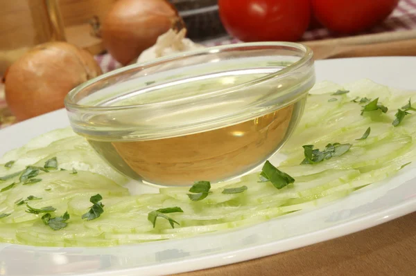 Fresh cucumber salad with a bowl of oil — Stock Photo, Image