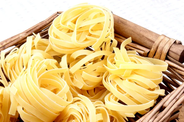 Some home made tagliatelle in a wicker basket — Stock Photo, Image