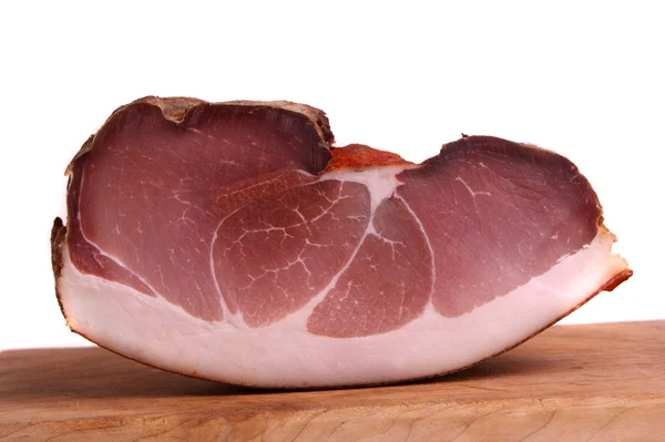 Cut and smoked ham on a wooden board — Stock Photo, Image