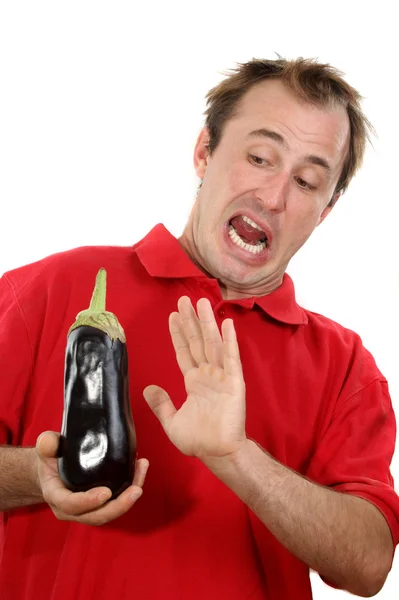 Young man with an eggplant in his hand — Stock Photo, Image