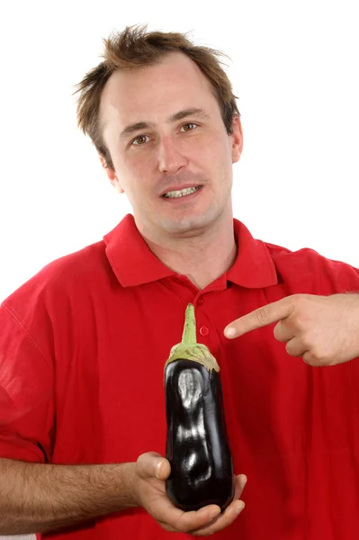 Young man with an eggplant in his hand — Stock Photo, Image