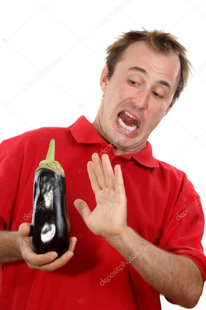 Young man with an eggplant in his hand