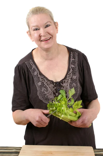 Celery is cut with a small kitchen knife — Stock Photo, Image