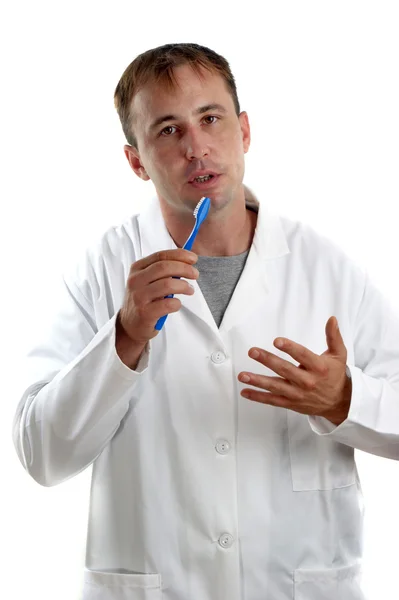 Pessoal médico explica a função de uma escova de dentes — Fotografia de Stock