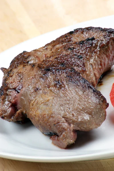 Grilled ostrich steak with tomato on a plate — Stock Photo, Image