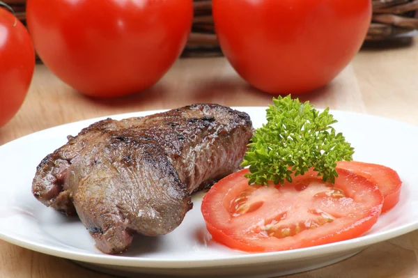 Grilled ostrich steak with parsley on a plate — Stock Photo, Image