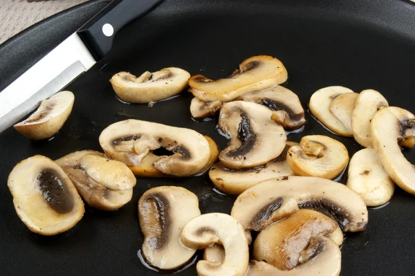 Нарізані та смажені гриби на сковороді — стокове фото