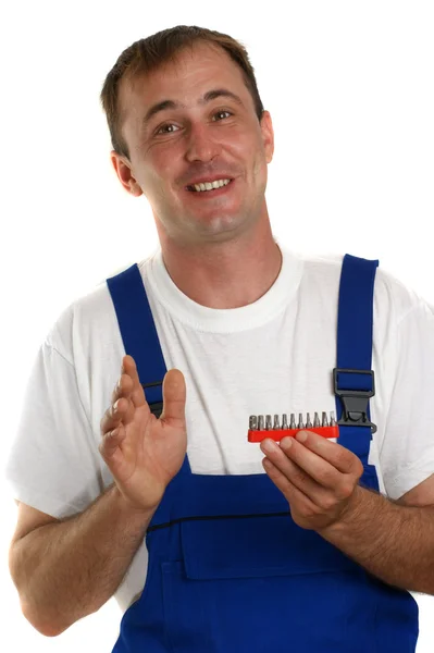 スクリュー セットを保持している青いオーバー オールで職人 — ストック写真