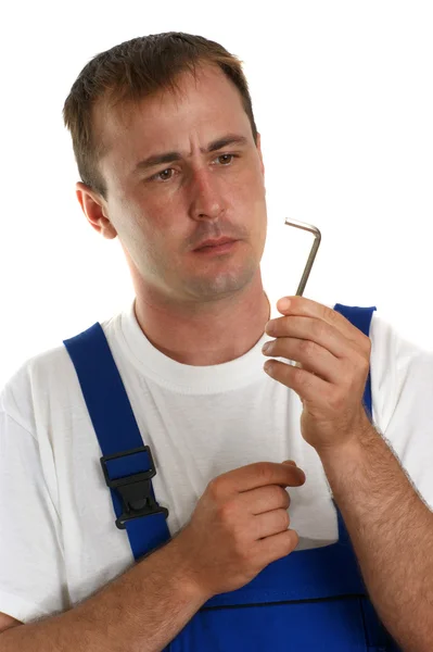 Artesanos en mono azul sosteniendo una llave allen — Foto de Stock