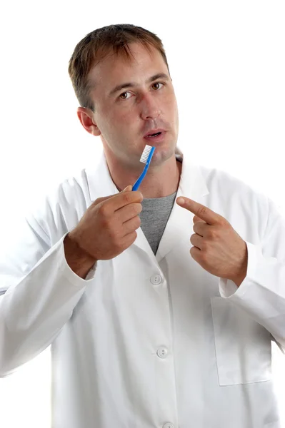 Personel medyczny wyjaśnia funkcję szczoteczki do zębów — Zdjęcie stockowe