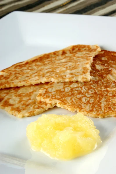 Homemade pancake with applesauce on a white plate — Stock Photo, Image
